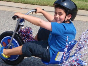 Boy on big wheel